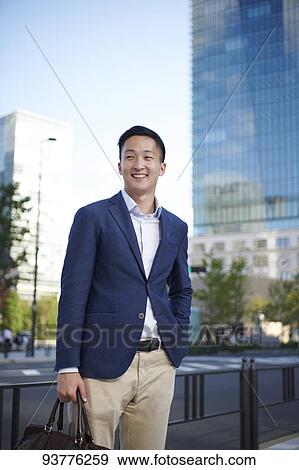 Young Japanese businessman downtown Tokyo View Large Photo Image Stock Photo - Young Japanese businessman downtown Tokyo. Fotosearch