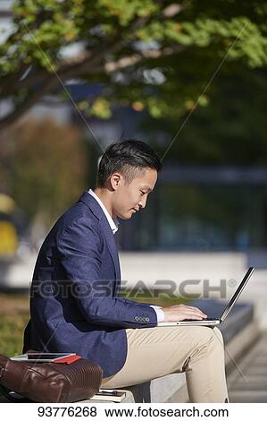 Young Japanese businessman downtown Tokyo View Large Photo Image Stock Photo - Young Japanese businessman downtown Tokyo. Fotosearch