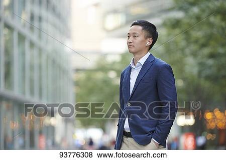 Young Japanese businessman downtown Tokyo View Large Photo Image Stock Photo - Young Japanese businessman downtown Tokyo. Fotosearch