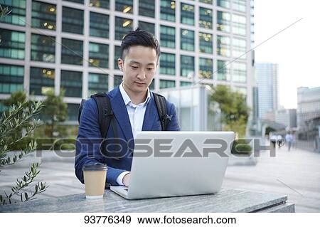 Young Japanese businessman downtown Tokyo View Large Photo Image Stock Photo - Young Japanese businessman downtown Tokyo. Fotosearch