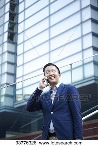 Stock Photograph - Young Japanese businessman downtown Tokyo. Fotosearch