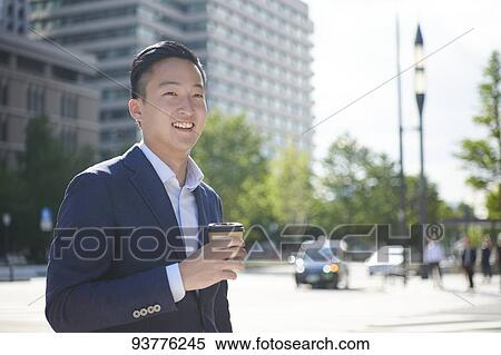 Stock Photography - Young Japanese businessman downtown Tokyo. Fotosearch