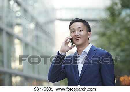 Stock Photography - Young Japanese businessman downtown Tokyo. Fotosearch