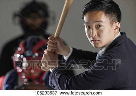Young Japanese businessman in a suit playing baseball View Large Photo Image Stock Photo - Young Japanese businessman in a suit playing baseball. Fotosearch