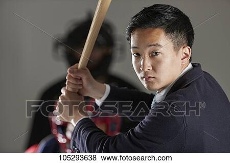 Young Japanese businessman in a suit playing baseball View Large Photo Image Stock Photo - Young Japanese businessman in a suit playing baseball. Fotosearch