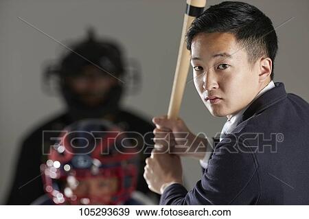 Young Japanese businessman in a suit playing baseball View Large Photo Image Stock Photo - Young Japanese businessman in a suit playing baseball. Fotosearch