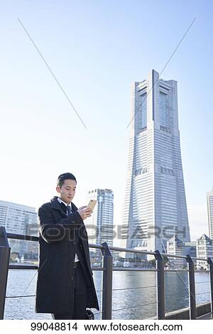 Young Japanese businessman outside View Large Photo Image Picture - Young Japanese businessman outside. Fotosearch