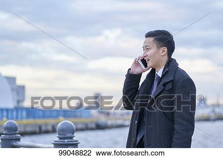 Young Japanese businessman outside View Large Photo Image Stock Image - Young Japanese businessman outside. Fotosearch