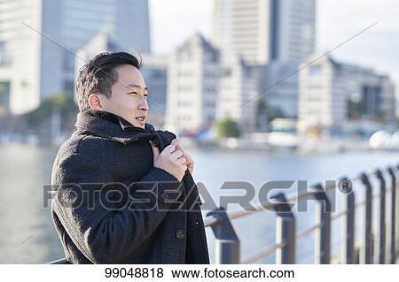 Young Japanese businessman outside View Large Photo Image Stock Photo - Young Japanese businessman outside. Fotosearch