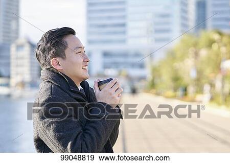 Young Japanese businessman outside View Large Photo Image Stock Photo - Young Japanese businessman outside. Fotosearch