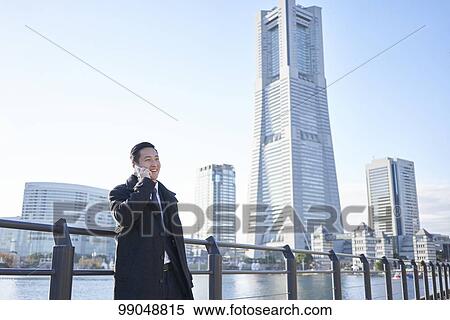 Stock Photography - Young Japanese businessman outside. Fotosearch