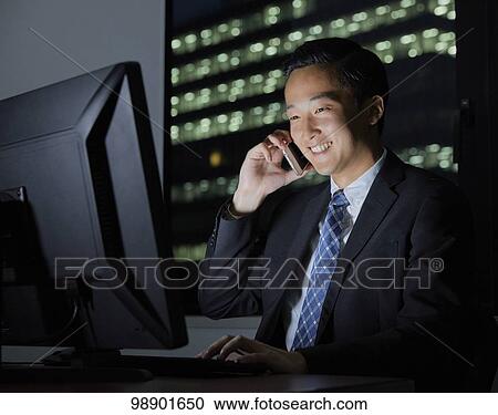 Young Japanese businessman working late at night View Large Photo Image Stock Image - Young Japanese businessman working late at night. Fotosearch