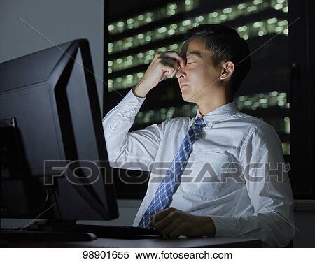 Young Japanese businessman working late at night View Large Photo Image Stock Photography - Young Japanese businessman working late at night. Fotosearch