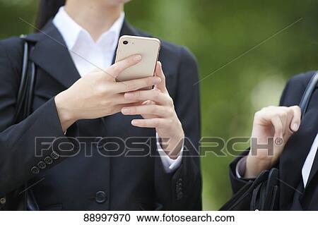 Stock Image - Young Japanese businesspeople. Fotosearch