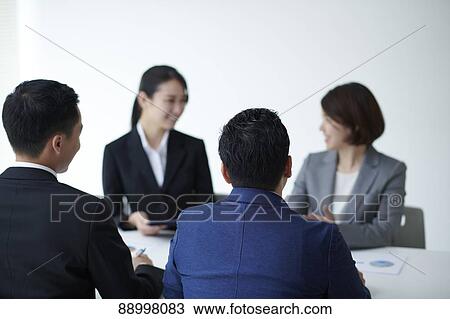 Stock Image - Young Japanese businesspeople. Fotosearch