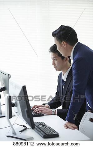 Stock Image - Young Japanese businesspeople. Fotosearch