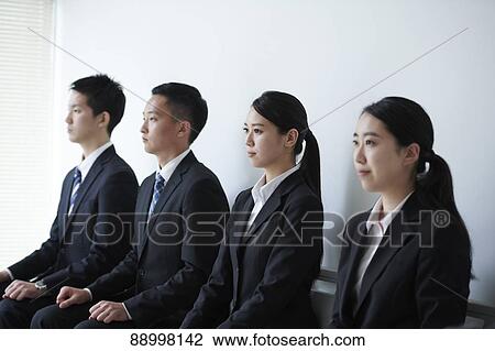 Stock Image - Young Japanese businesspeople. Fotosearch