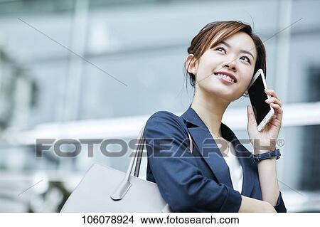 Picture - Young Japanese businesswoman downtown. Fotosearch