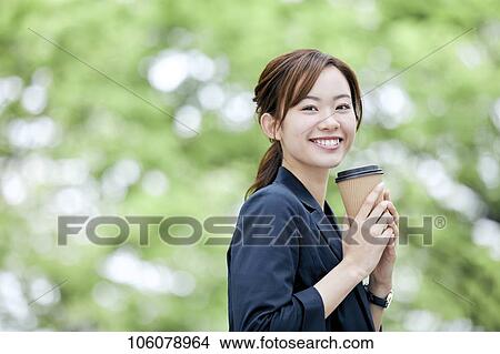 Picture - Young Japanese businesswoman downtown. Fotosearch