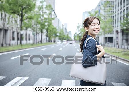 Stock Image - Young Japanese businesswoman downtown. Fotosearch