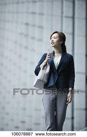 Stock Photo - Young Japanese businesswoman downtown. Fotosearch