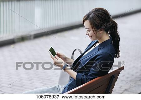 Young Japanese businesswoman downtown View Large Photo Image Stock Photo - Young Japanese businesswoman downtown. Fotosearch