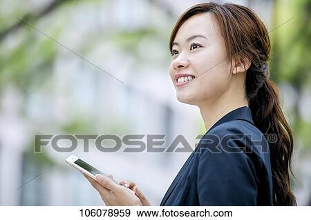 Young Japanese businesswoman downtown View Large Photo Image Stock Photo - Young Japanese businesswoman downtown. Fotosearch