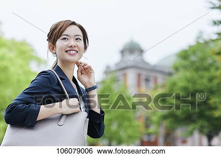 Stock Photograph - Young Japanese businesswoman downtown. Fotosearch