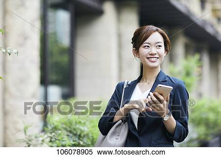 Stock Photography - Young Japanese businesswoman downtown. Fotosearch