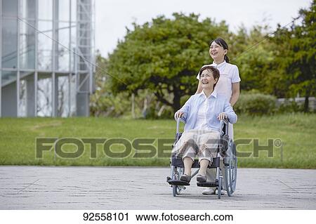 Young Japanese caregiver taking care of elder patient View Large Photo Image Stock Image - Young Japanese caregiver taking care of elder patient. Fotosearch