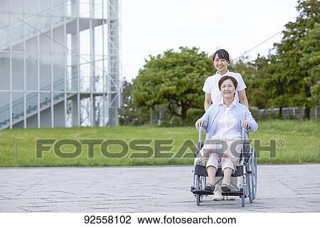 Young Japanese caregiver taking care of elder patient View Large Photo Image Stock Image - Young Japanese caregiver taking care of elder patient. Fotosearch