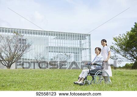 Young Japanese caregiver taking care of elder patient View Large Photo Image Stock Image - Young Japanese caregiver taking care of elder patient. Fotosearch