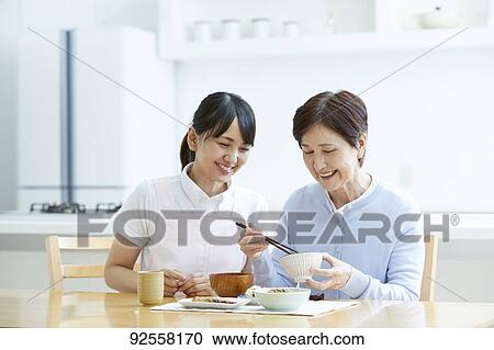 Young Japanese caregiver taking care of elder patient View Large Photo Image Stock Image - Young Japanese caregiver taking care of elder patient. Fotosearch