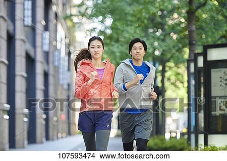 Young Japanese couple running downtown Tokyo View Large Photo Image Picture - Young Japanese couple running downtown Tokyo. Fotosearch