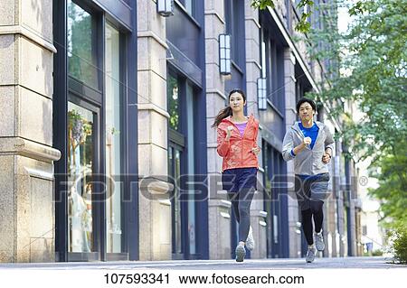 Young Japanese couple running downtown Tokyo View Large Photo Image Stock Image - Young Japanese couple running downtown Tokyo. Fotosearch
