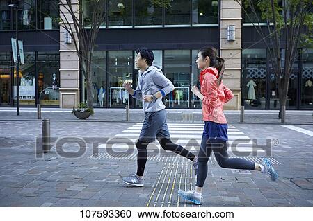 Young Japanese couple running downtown Tokyo View Large Photo Image Stock Image - Young Japanese couple running downtown Tokyo. Fotosearch
