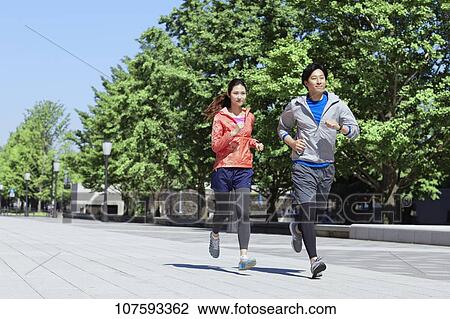 Young Japanese couple running downtown Tokyo View Large Photo Image Stock Image - Young Japanese couple running downtown Tokyo. Fotosearch
