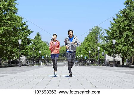 Young Japanese couple running downtown Tokyo View Large Photo Image Stock Image - Young Japanese couple running downtown Tokyo. Fotosearch