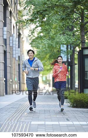 Young Japanese couple running downtown Tokyo View Large Photo Image Stock Image - Young Japanese couple running downtown Tokyo. Fotosearch