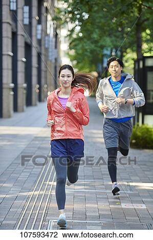 Young Japanese couple running downtown Tokyo View Large Photo Image Stock Image - Young Japanese couple running downtown Tokyo. Fotosearch