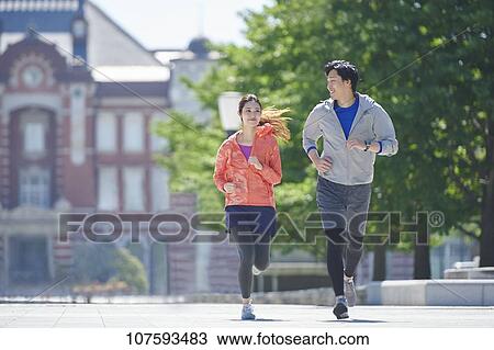 Young Japanese couple running downtown Tokyo View Large Photo Image Stock Image - Young Japanese couple running downtown Tokyo. Fotosearch