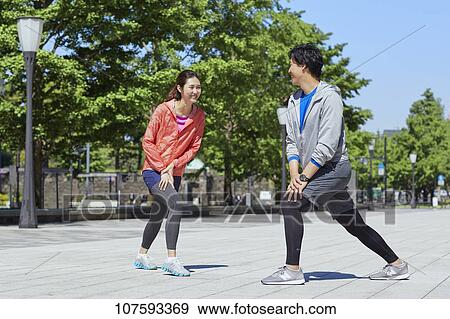 Young Japanese couple running downtown Tokyo View Large Photo Image Stock Photo - Young Japanese couple running downtown Tokyo. Fotosearch