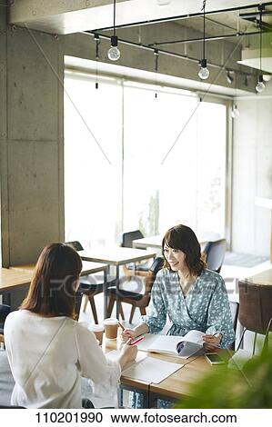 Stock Image - Young Japanese friends having fun together. Fotosearch