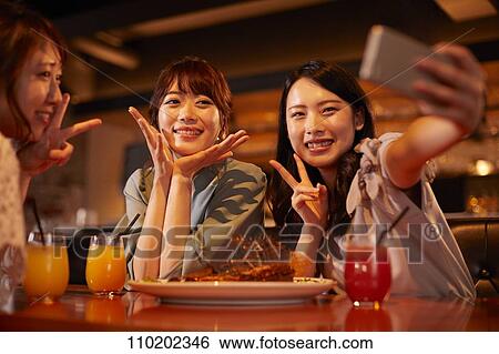 Young Japanese friends having fun together View Large Photo Image Stock Photograph - Young Japanese friends having fun together. Fotosearch