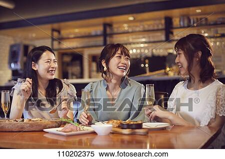 Stock Photography - Young Japanese friends having fun together. Fotosearch