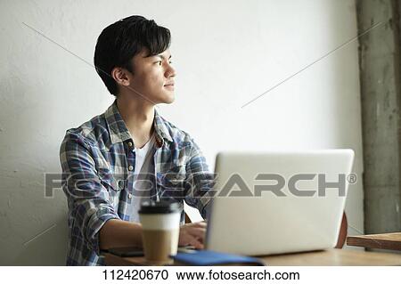 Young Japanese man at a cafe View Large Photo Image Stock Image - Young Japanese man at a cafe. Fotosearch