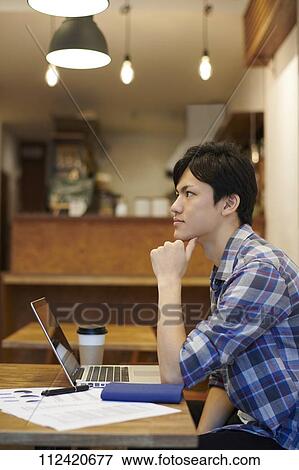 Young Japanese man at a cafe View Large Photo Image Stock Photo - Young Japanese man at a cafe. Fotosearch