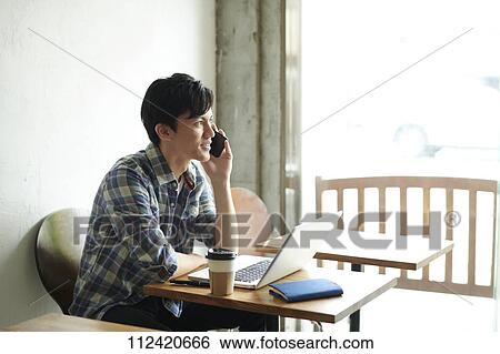 Young Japanese man at a cafe View Large Photo Image Stock Photograph - Young Japanese man at a cafe. Fotosearch