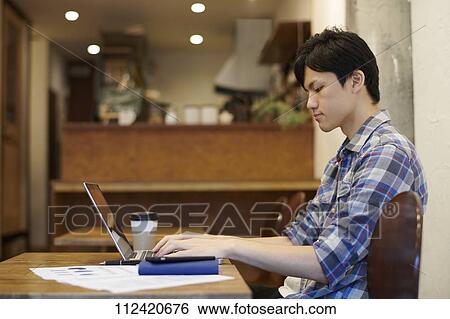 Young Japanese man at a cafe View Large Photo Image Stock Photograph - Young Japanese man at a cafe. Fotosearch