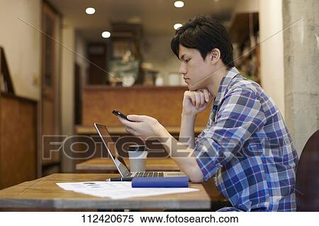 Young Japanese man at a cafe View Large Photo Image Stock Photography - Young Japanese man at a cafe. Fotosearch